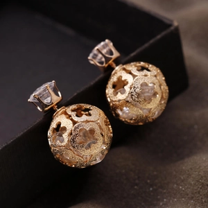 Exquisite hollow floral gold spherical earrings with sparkling diamond stud accents
