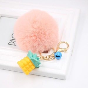 Pink fluffy pom pom keychain with gold resin pineapple pendant and blue bell detail