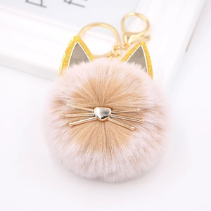 Detailed view of pink cat plush pompom keychain with golden ears and metallic whiskers
