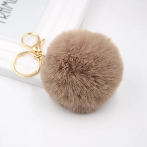 Detailed close-up of 8cm fluffy faux rabbit fur keychain with golden lobster clasp
