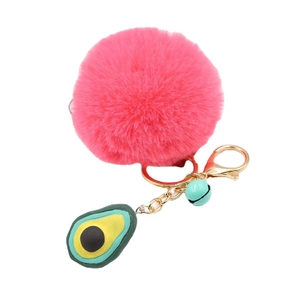 Bright pink faux fur pompom keychain with green avocado pendant and gold ring
