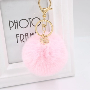 Pink plush snowball keychain with golden alloy snowflake pendant and lobster clasp