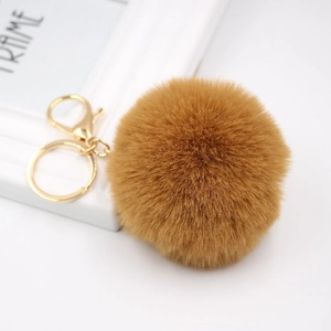Detailed close-up of fluffy 8cm faux rabbit fur keychain with gold-tone metal lobster clasp