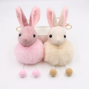Cute plush bunny pom-pom keychain in pink and beige colors with gold-tone ring
