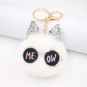 White plush cat keychain with silver sequin ears and ME OW glasses on white background