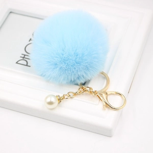 Light blue faux fur pompom keychain with white pearl accent and golden lobster clasp