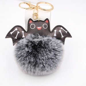 Close-up of Halloween bat pompom keychain with faux fur and golden metal clasp