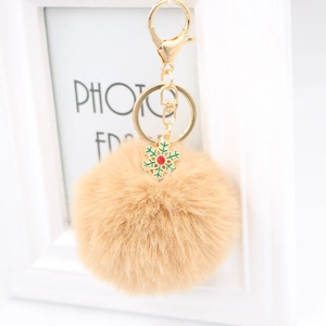 Porte-clés pompon en fourrure synthétique camel avec fermoir doré et flocon vert