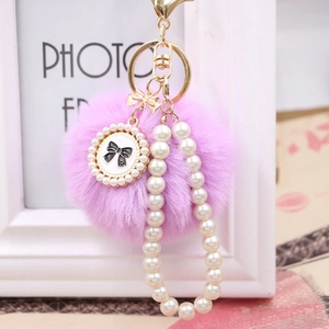 Pink faux rabbit fur pompom keychain with pearl chain and bow pendant charm