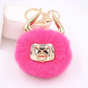 Hot pink fluffy bull head keychain with golden horns and matching metal keyring