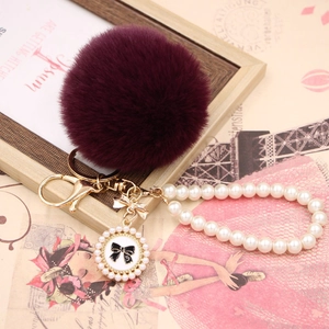 Deep purple faux rabbit fur ball keychain with gold bow and pearl chain pendant