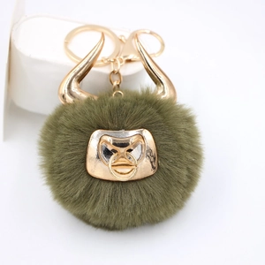 Army green bull faux fur pompom keychain with golden horns and metal bull head charm