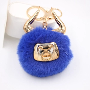 Detailed view of royal blue bull plush keychain with gold horns and lobster clasp