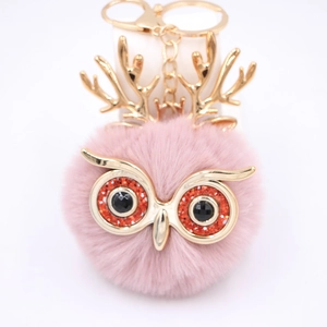 Détail du pendentif hibou en fausse fourrure rose avec bois dorés et fermoir métal
