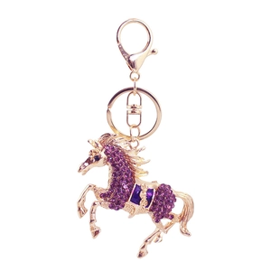 Golden flying horse keychain with purple rhinestones and enamel for bag decor