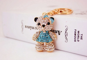 Close-up of crystal-encrusted bear keychain with blue rhinestones and gold alloy hardware