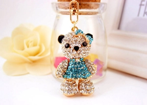 Detail of crystal bear keychain with peacock blue rhinestones and golden hook