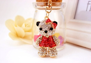 Macro view of crystal bear keychain with sparkling red rhinestones and gold lobster clasp