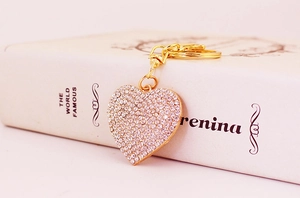 Detailed close-up of sparkling heart rhinestone keychain with golden metal clasp