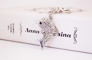 Macro detail of dolphin keychain featuring shimmering crystals and polished silver finish