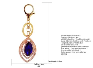 Detailed view of peacock feather keychain with blue crystal and size measurements