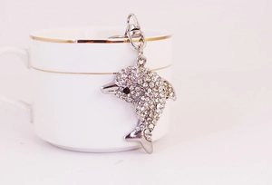 Detailed macro view of silver dolphin keychain with sparkling white rhinestones and lobster clasp