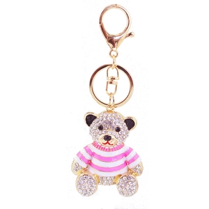 Golden bear keychain with sparkling white rhinestones and pink striped shirt detail