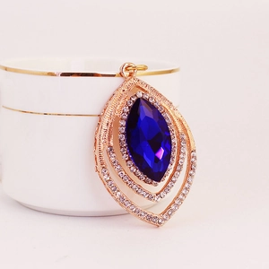 Peacock feather pendant with deep blue crystal and rose gold setting for keychain