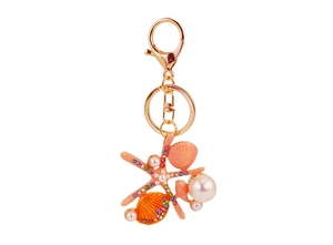 Détails du porte-clés doré avec étoile de mer orange, coquillages et perles blanches