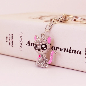 Elegant silver sitting cat keychain with sparkling white rhinestones and pink enamel accents