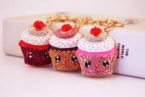 Close-up of cupcake keychains with sparkling crystals and cute cartoon expressions