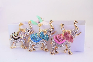 Gros plan des porte-clés éléphant en strass avec détails en émail noir bleu et rose