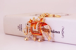 Detail view of colorful enamel elephant keychain with sparkling rhinestones and gold hooks