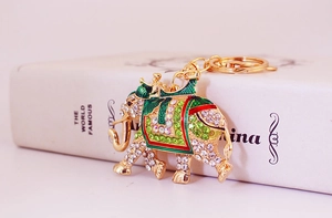 Detailed close-up of a sparkling rhinestone elephant keychain with gold alloy finish