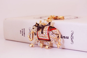 Close-up of golden elephant keychain with sparkling rhinestones and enamel details