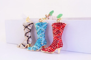 Detailed close-up of rhinestone boots keychains with blue, red, and silver crystals