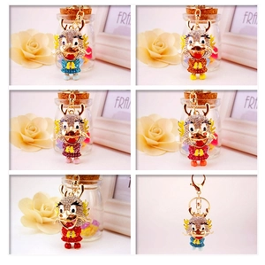 Detail showing five colorful rhinestone dragon keychains with gold lobster clasps