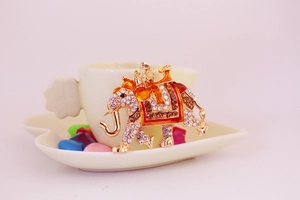 Detailed macro view of a gold elephant keychain with rhinestones and enamel patterns