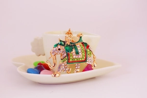 Close-up of golden elephant keychain with sparkling rhinestones and colorful enamel detail