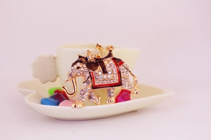 Macro shot of a colorful rhinestone elephant pendant with intricate gold-plated details