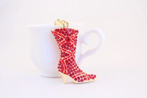 Detail of red rhinestone high heel boot keychain with gold alloy base and metal ring