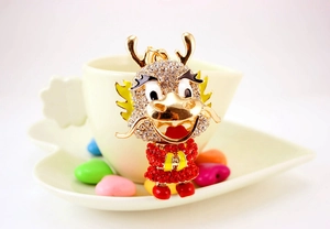 Close-up of cute Chinese zodiac dragon keychain with red and white rhinestones
