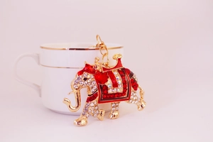 Detail of a sparkling crystal elephant keychain with red enamel on a gold metal base