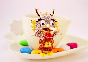 Detail view of a Chinese dragon keychain with colorful rhinestones and gold plating