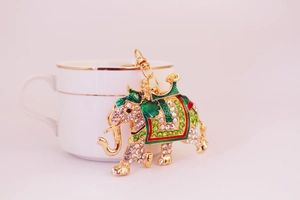 Close-up of elephant keychain showing detailed green rhinestones and colorful enamel work