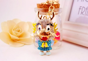 Close-up of cute Chinese dragon keychain with sparkling blue and white rhinestones