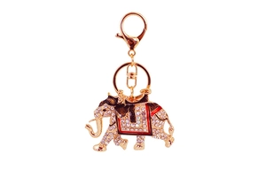 Detailed macro view of crystal elephant keychain with red and black enamel accents