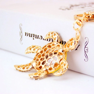 Cute crystal sea turtle keychain in gold alloy with sparkling white rhinestones