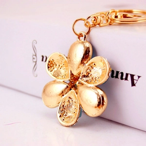 Elegant gold flower keychain with crystal rhinestones and textured petals for bag decor