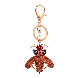 Portachiavi a forma di ape dorata con strass color ambra e una corona rossa